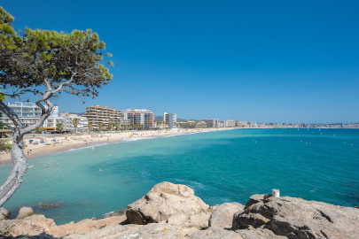 Beach of Sant Antoni taken from Torrevalentina and showing blue sea, blue sky en the boulevard.
