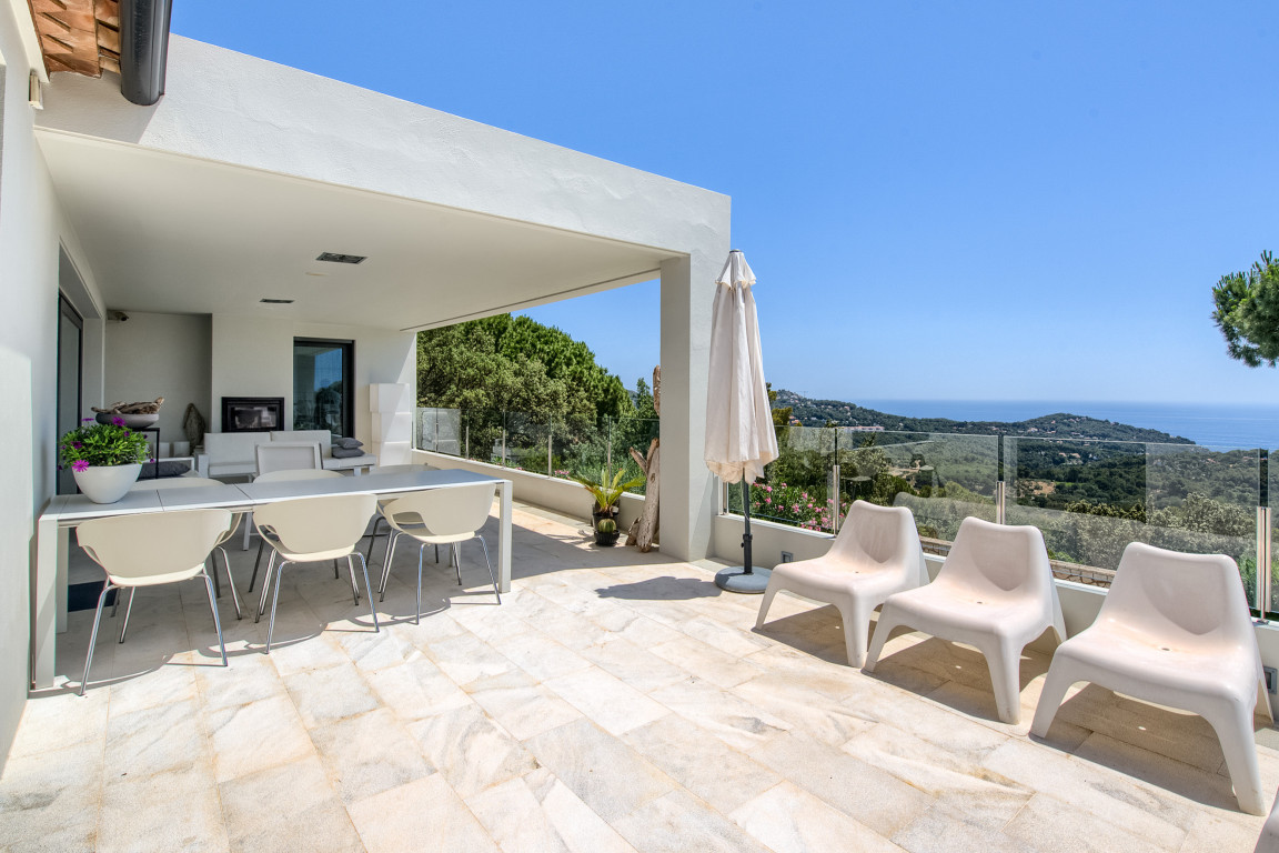 Terrace of modern property with at the background view over the Mediterraan sea in Begur.