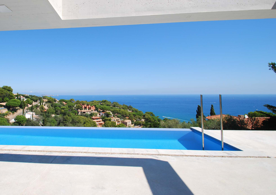 Views over the infinity pool and Mediterranean sea from the terrace of a luxury property at the Costa Brava.