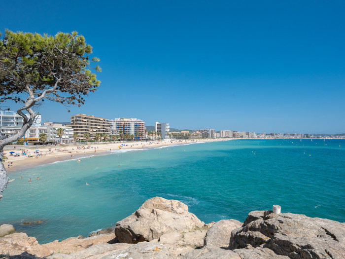 Beach of Sant Antoni taken from Torrevalentina and showing blue sea, blue sky en the boulevard.