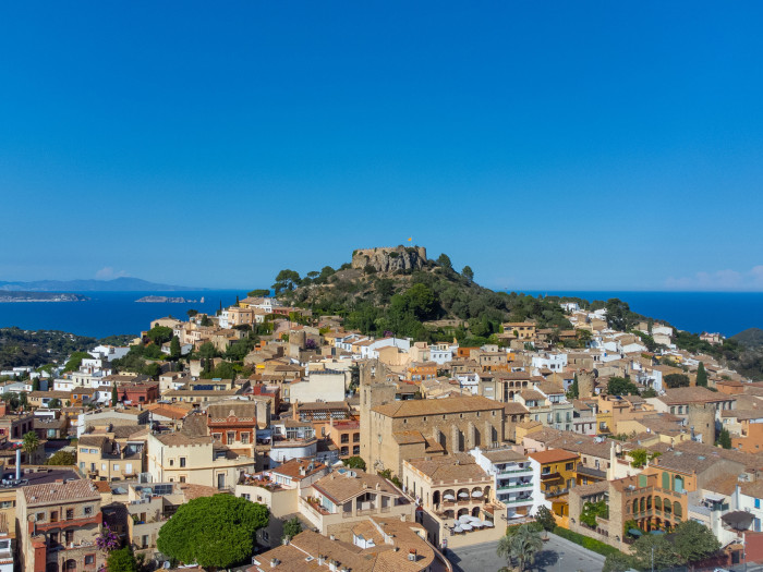 Center of Begur with castle and in the background the Mediterranean sea and Cape Creus.