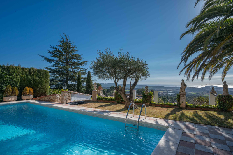 Swimming pool with sea view in garden of villa in Calonge.